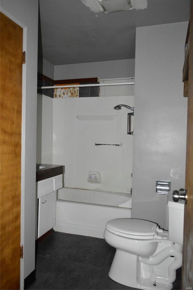 full bathroom featuring tile patterned floors, vanity, toilet, and shower / washtub combination