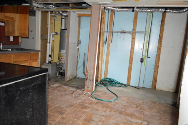 basement featuring water heater and sink