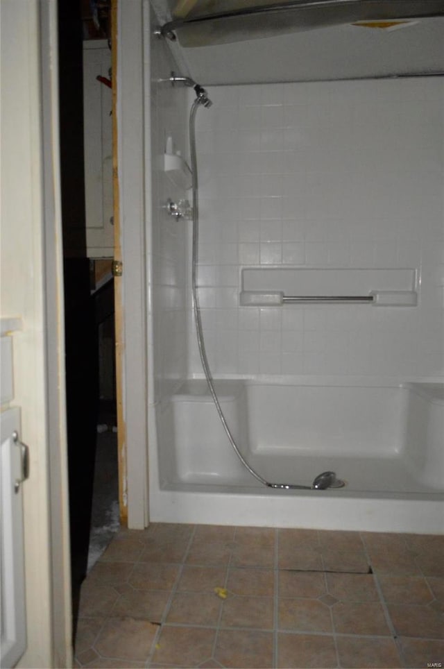 bathroom with tile patterned floors and a shower