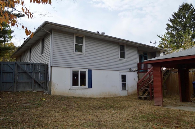 back of property featuring a lawn