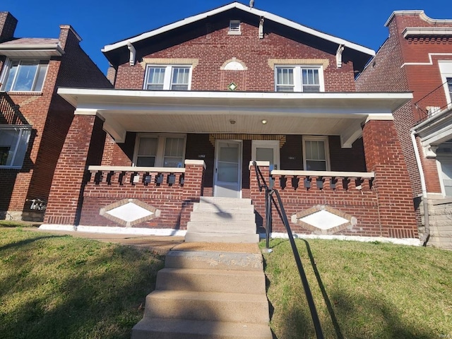 view of front of house featuring a porch and a front lawn