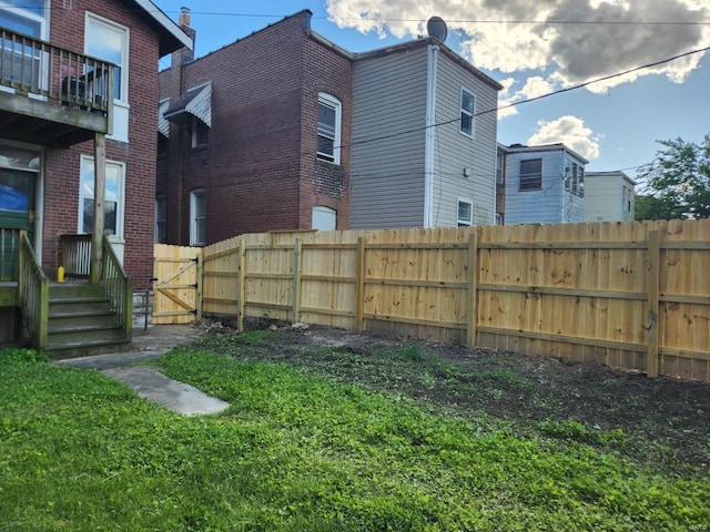 view of yard with a balcony