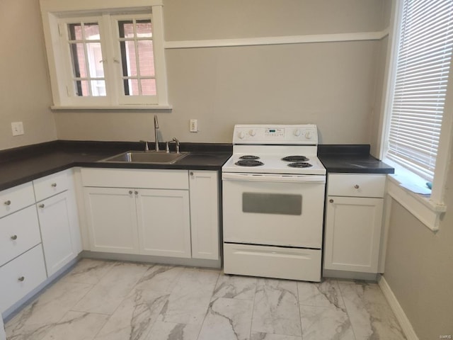 kitchen featuring white electric range oven, sink, white cabinetry, and plenty of natural light