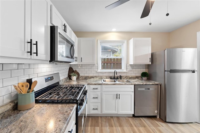 kitchen with white cabinets, stainless steel appliances, and sink