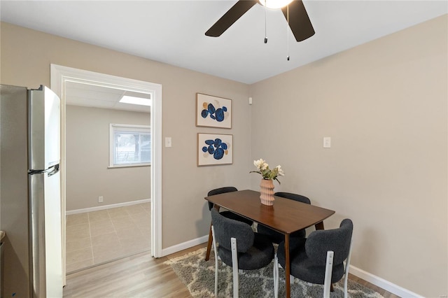 dining space featuring light hardwood / wood-style flooring and ceiling fan