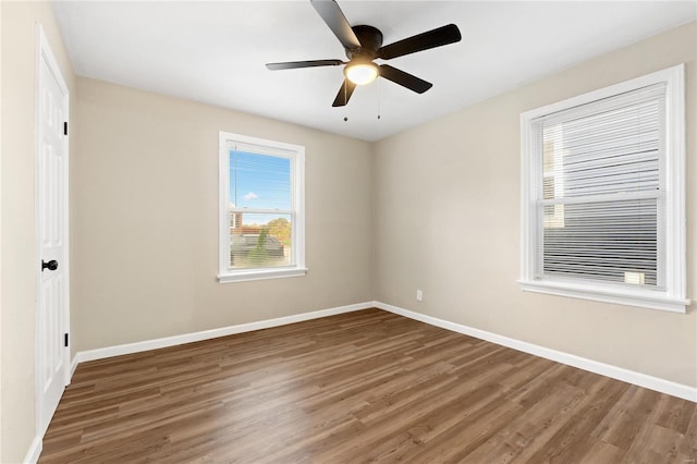 empty room featuring dark hardwood / wood-style floors and ceiling fan