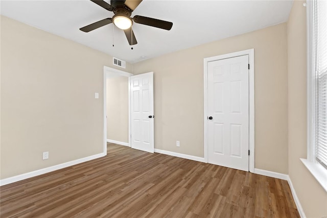 unfurnished bedroom with hardwood / wood-style flooring and ceiling fan