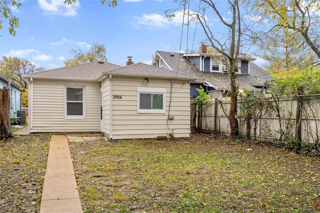 rear view of house with a yard