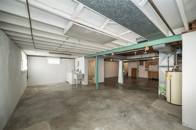 below grade area featuring water heater and a sink