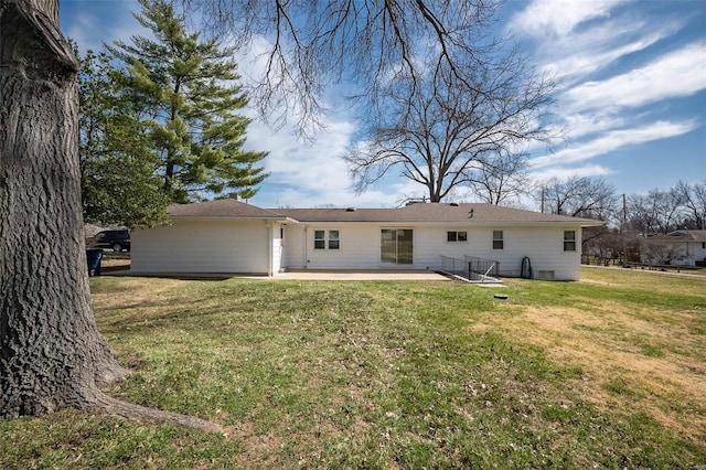 back of property featuring a yard and a patio