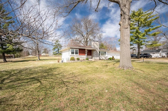 single story home with a front lawn, a garage, stone siding, and a chimney