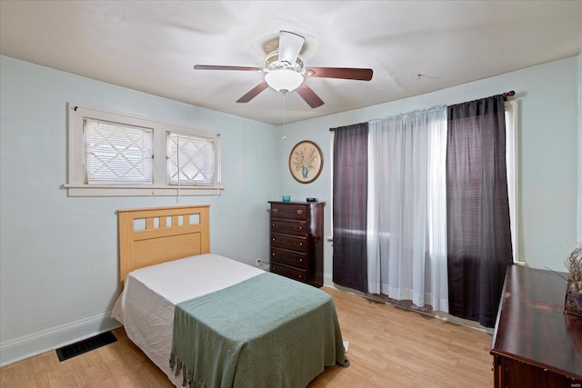 bedroom with light hardwood / wood-style flooring and ceiling fan