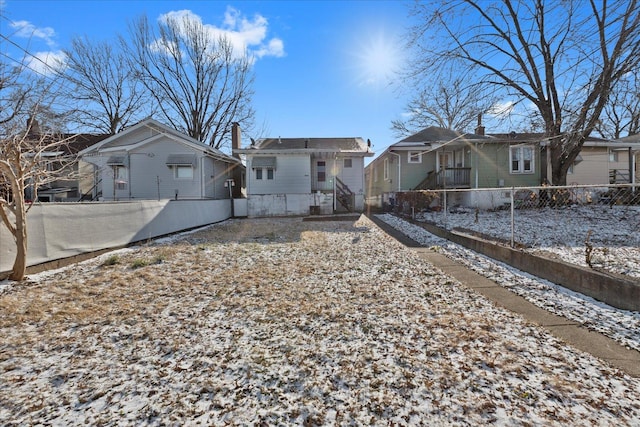 view of snow covered rear of property