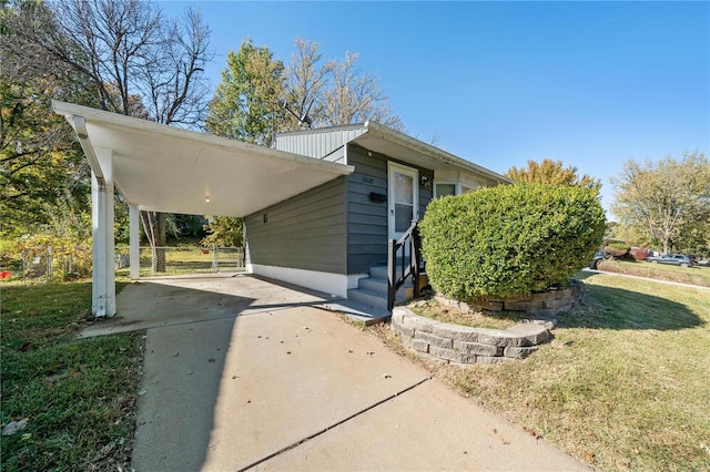 exterior space with a carport and a front yard