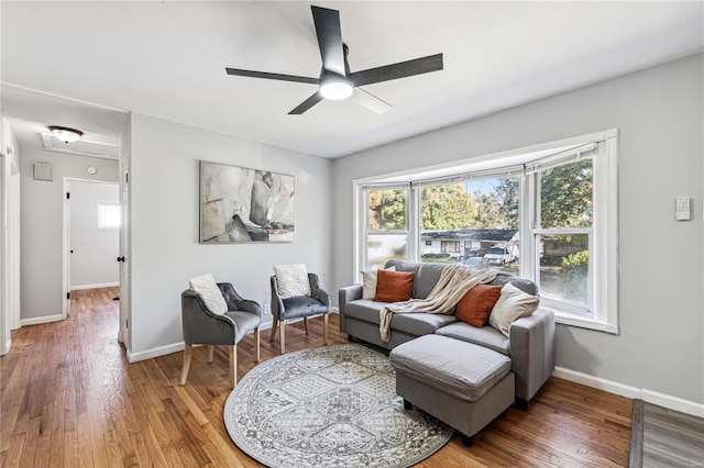 living room featuring hardwood / wood-style floors, ceiling fan, and plenty of natural light