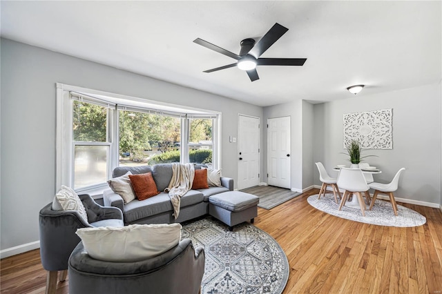 living room featuring hardwood / wood-style flooring and ceiling fan