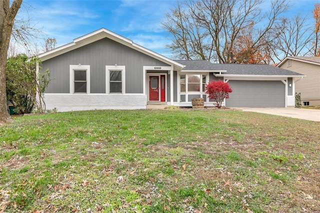 ranch-style home with a garage and a front lawn