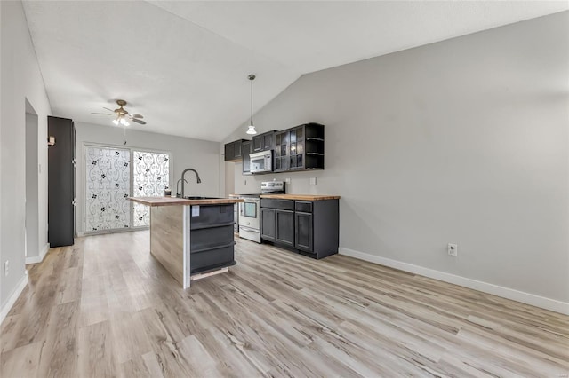 kitchen featuring lofted ceiling, stainless steel range with electric cooktop, wooden counters, hanging light fixtures, and light wood-type flooring