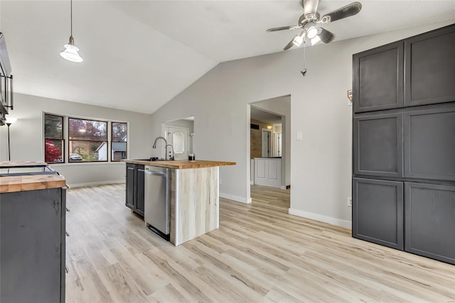 kitchen with dishwasher, vaulted ceiling, hanging light fixtures, and wooden counters