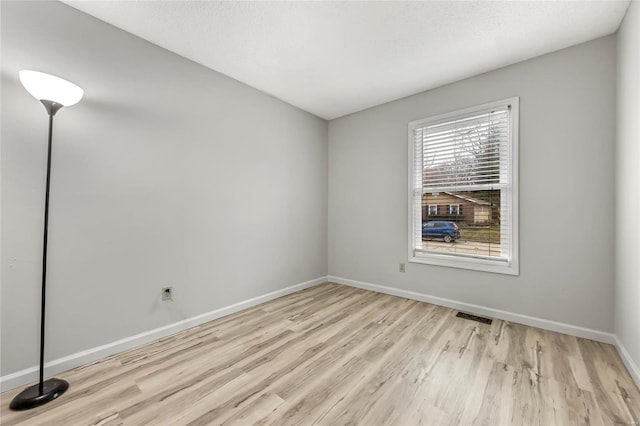 unfurnished room featuring light hardwood / wood-style floors