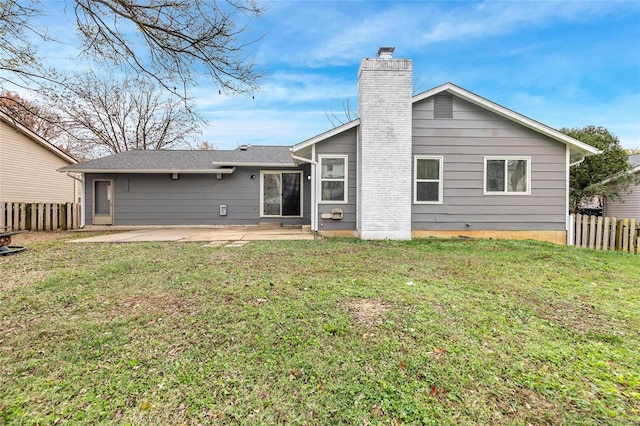 rear view of property with a patio area and a lawn