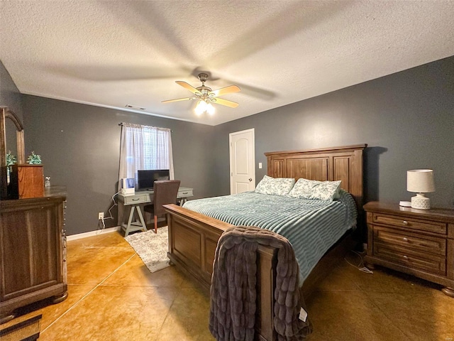 tiled bedroom with a textured ceiling and ceiling fan