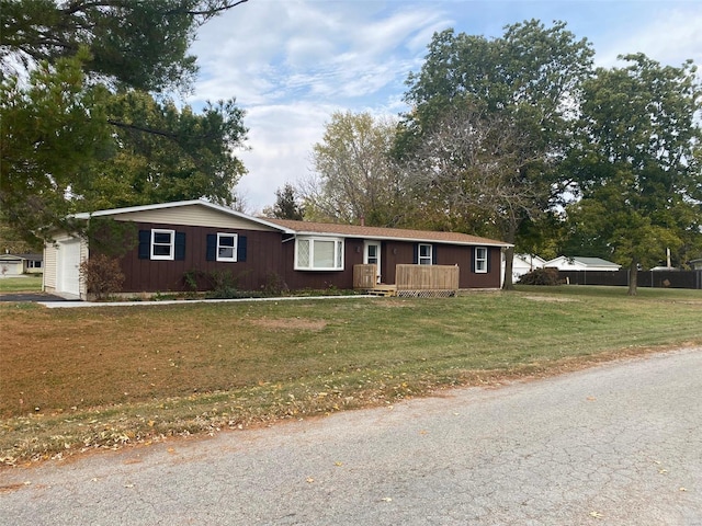 view of front of property with a front yard and a garage