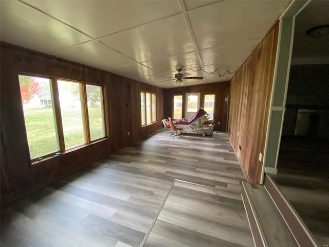 unfurnished sunroom with a healthy amount of sunlight and ceiling fan