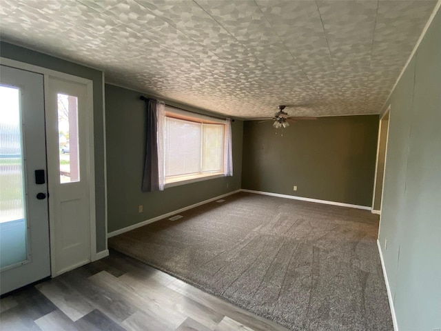 foyer entrance featuring ceiling fan, wood-type flooring, and a textured ceiling