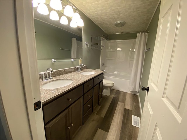 full bathroom with vanity, toilet, hardwood / wood-style flooring, and shower / bathtub combination with curtain