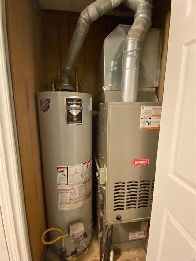 utility room featuring water heater and heating unit