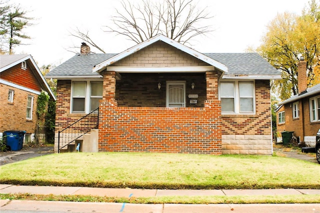 bungalow-style home with a front yard