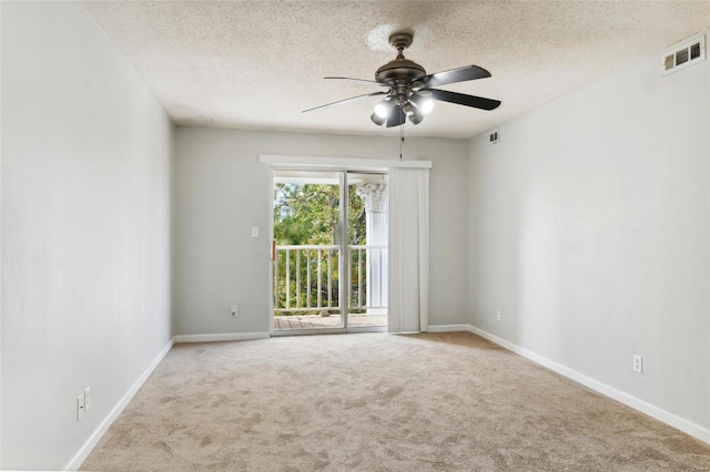 carpeted empty room with a textured ceiling and ceiling fan