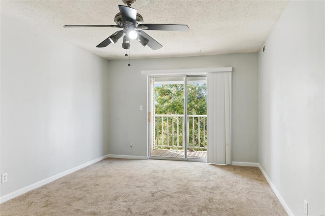 carpeted spare room with a textured ceiling and ceiling fan