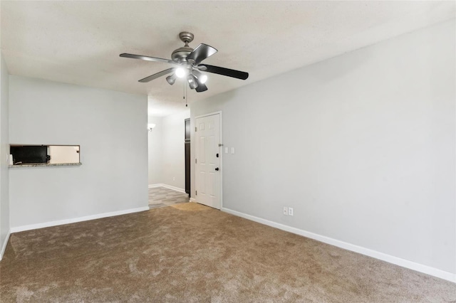 carpeted empty room with ceiling fan