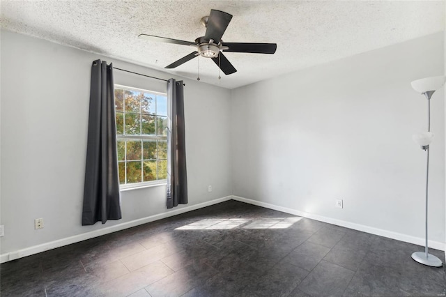 empty room with a textured ceiling and ceiling fan