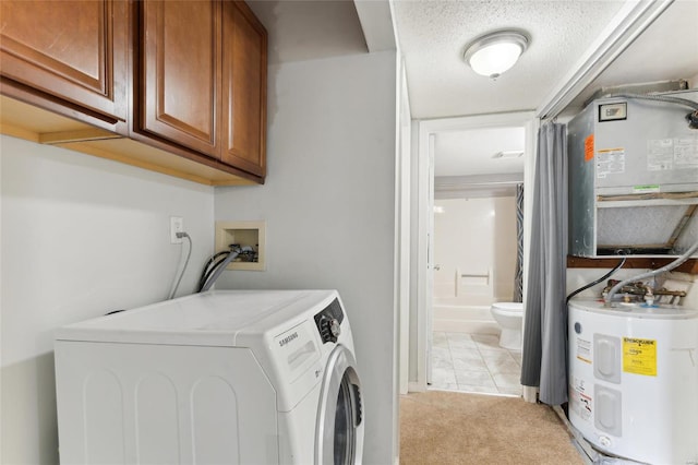 washroom with cabinets, electric water heater, a textured ceiling, separate washer and dryer, and light colored carpet