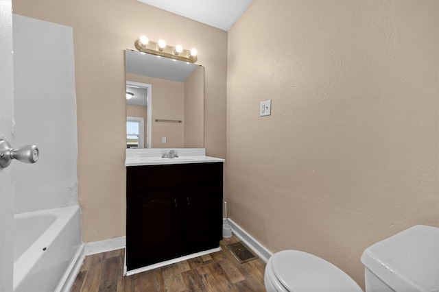 full bathroom featuring vanity, toilet, hardwood / wood-style flooring, and separate shower and tub