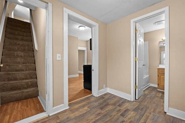 hallway with dark wood-type flooring