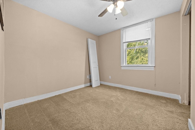 unfurnished bedroom featuring ceiling fan, carpet flooring, and a textured ceiling