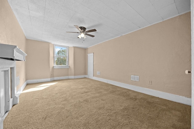 unfurnished living room featuring ornamental molding, carpet flooring, and ceiling fan