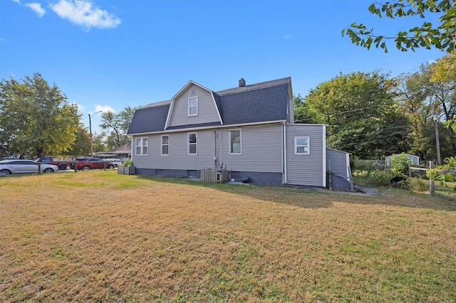 rear view of property featuring a yard