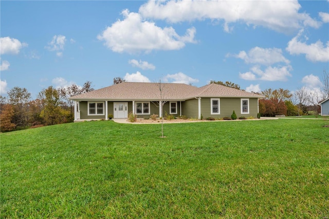 rear view of house featuring a lawn