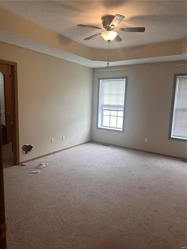 carpeted empty room with a textured ceiling and ceiling fan