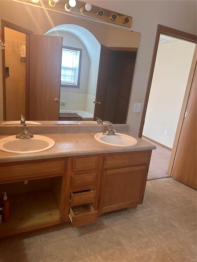 bathroom with vanity, a bathing tub, and tile patterned floors