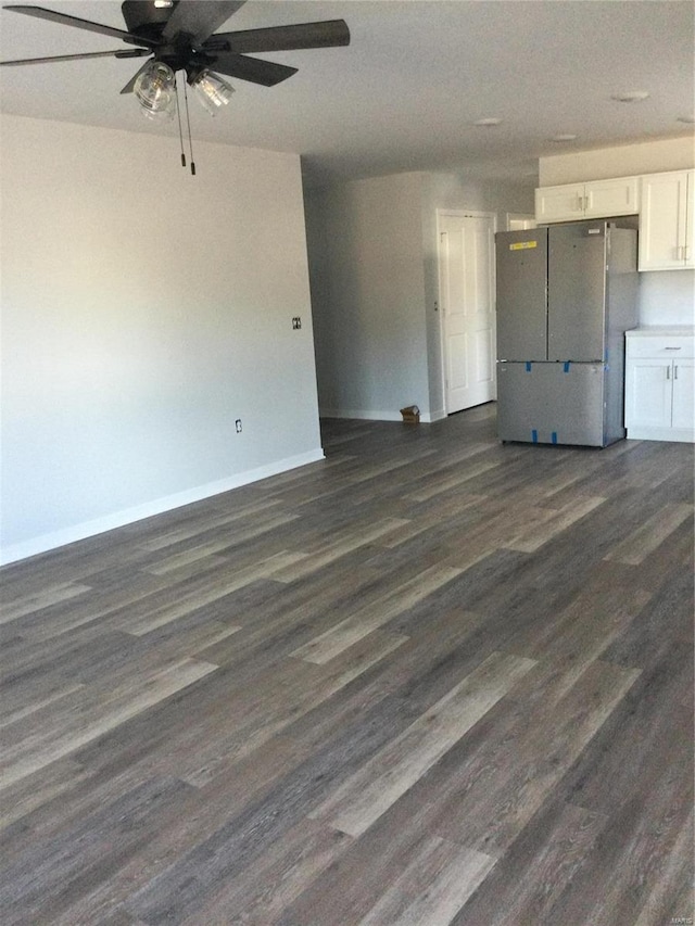 interior space with ceiling fan and dark hardwood / wood-style flooring