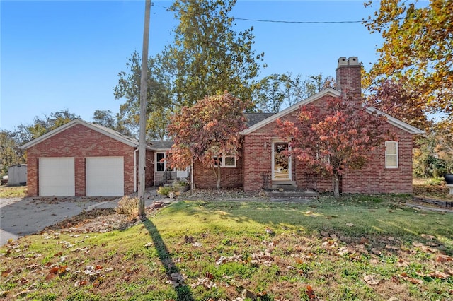 view of front of property with a front lawn and a garage