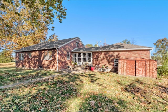 back of property featuring a yard and a patio area