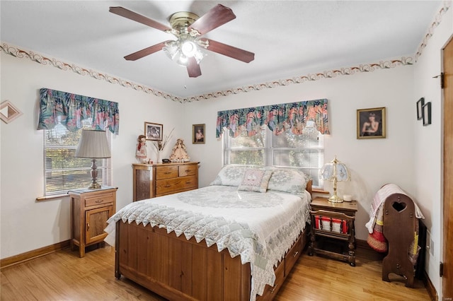 bedroom with light hardwood / wood-style floors and ceiling fan