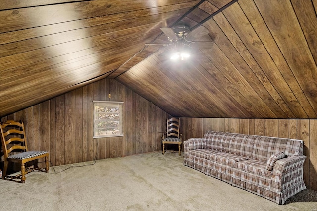 unfurnished room featuring wood walls, wooden ceiling, vaulted ceiling, light colored carpet, and ceiling fan